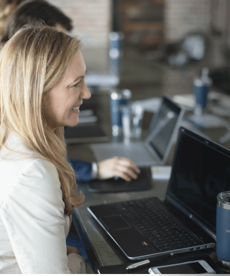 Woman sitting at desk discussing careers at Handler.
