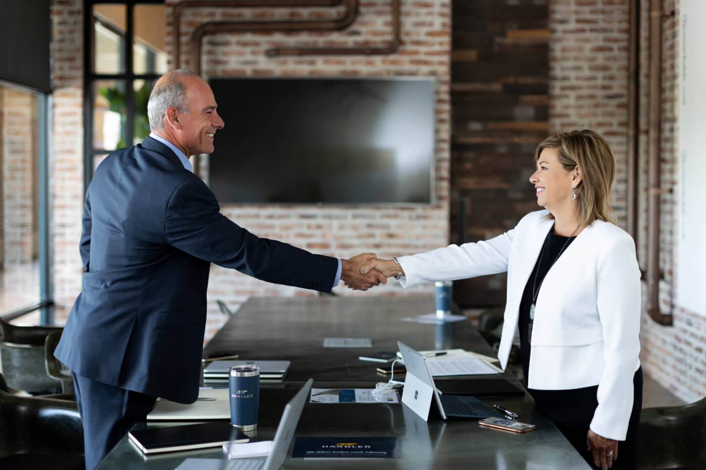Man and woman shaking hands - recruitment process outsourcing
