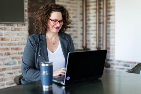 Woman typing on her laptop computer about Handler and recruiting top talent in Atlanta.