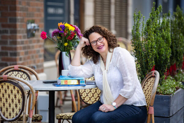 Nysie Henry sitting at a table with books