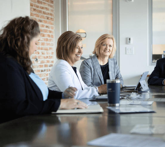 Members of Team Handler sitting at a conference table talking