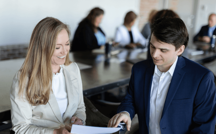 Man and woman talking about recruiting and how to deliver leaders worth following for Handler.
