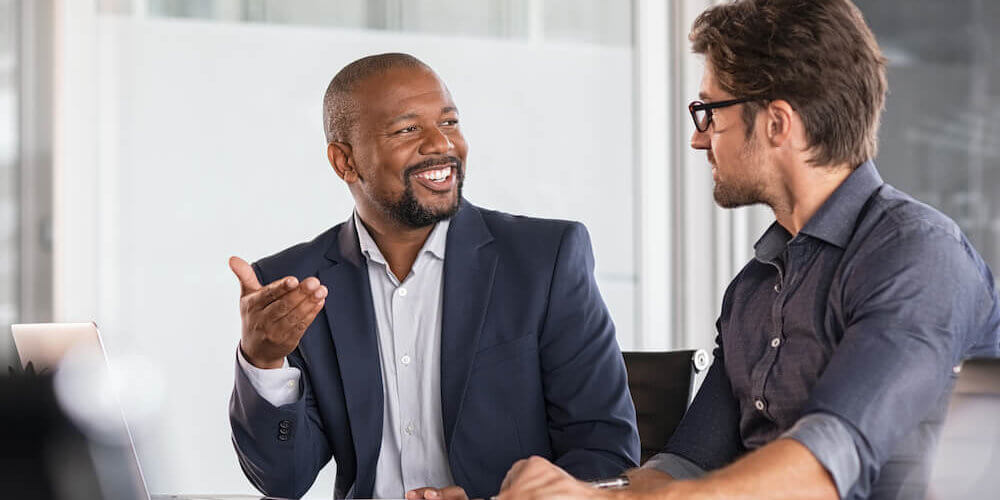 Two men having a meeting on how to develop leaders