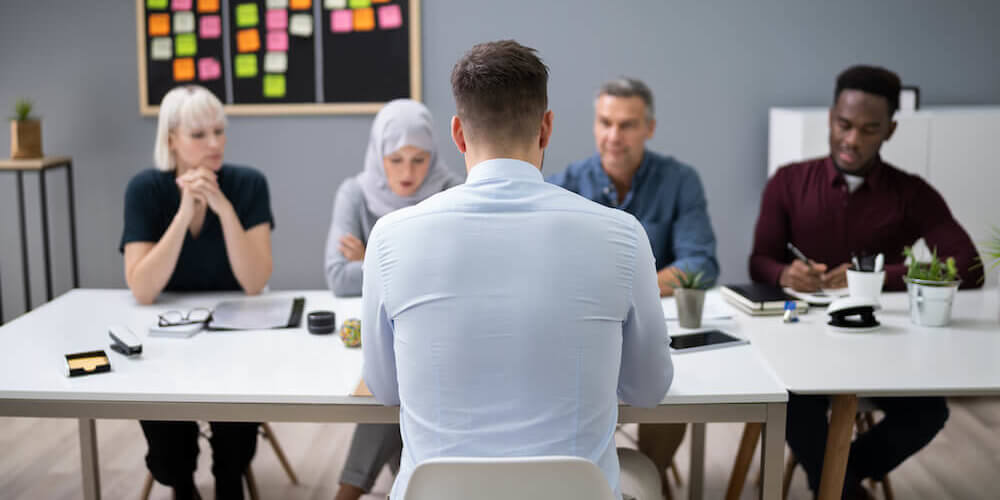 Man facing interview panel