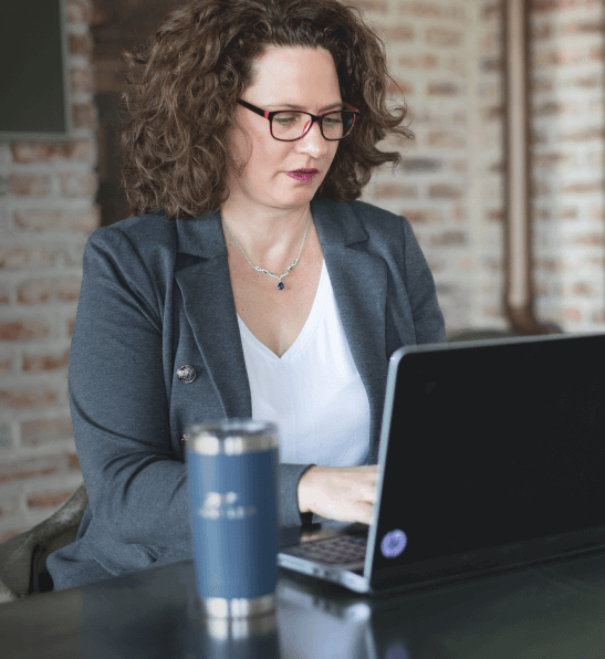 Woman typing on her laptop computer about Handler, top recruiting firm in Atlanta