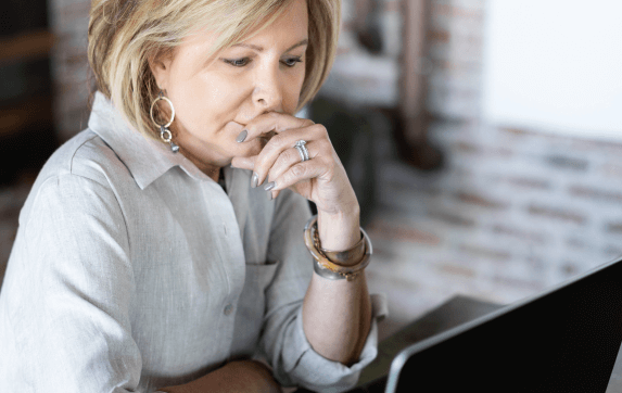 Woman sitting at computer working for Handler, recruiting firm in Atlanta.