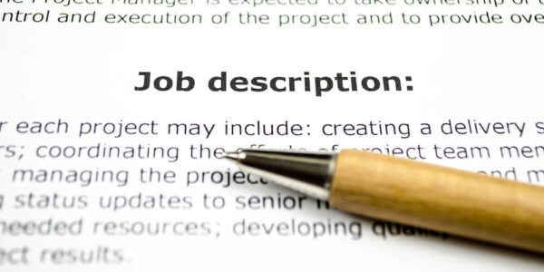 Pen sitting on top of job description paper - write a great job description