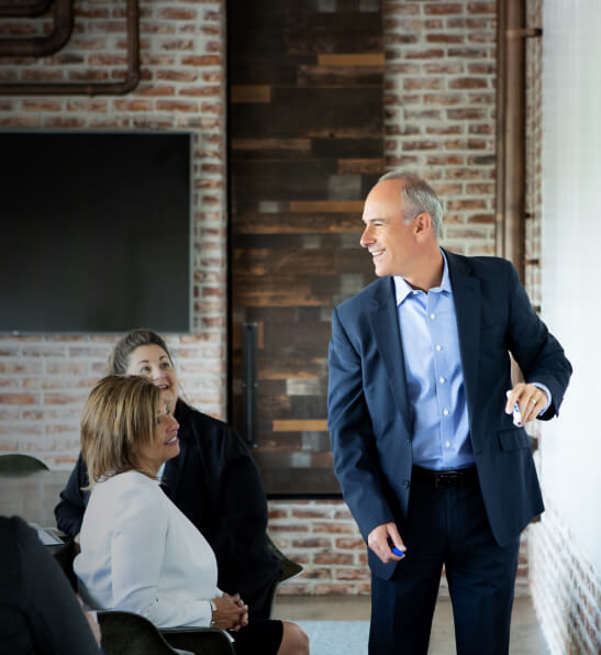 Eric Handler having a meeting with his team