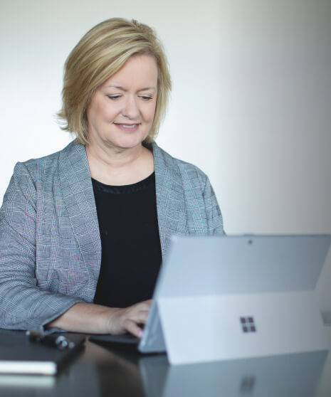 Woman typing on her laptop computer about Handler, top recruiting firm in Atlanta