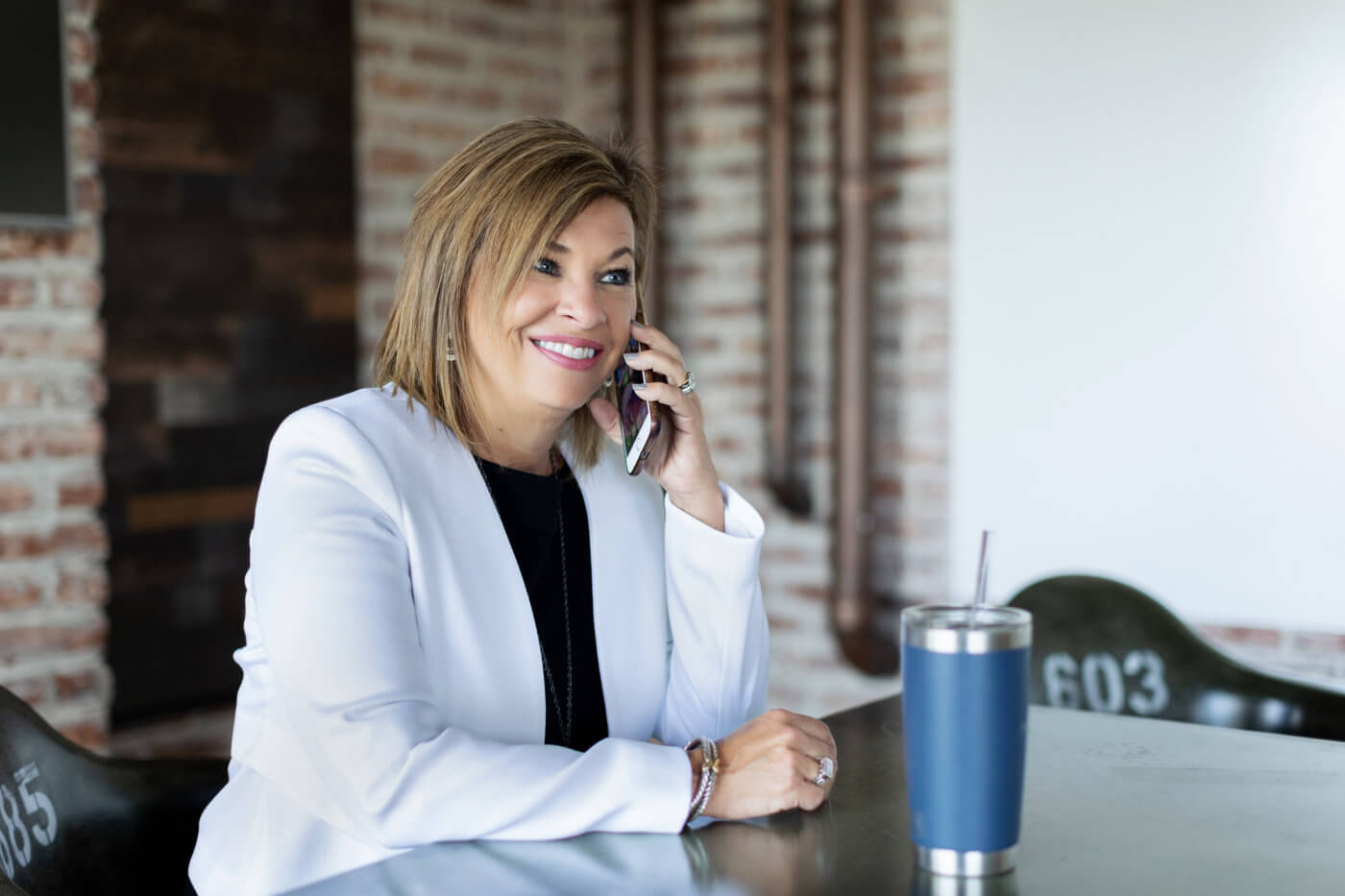 Woman talking on phone about 'life-work balance,' at Handler.