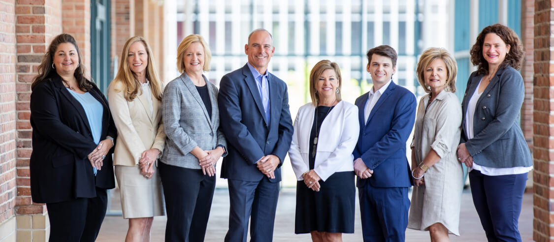 Team Handler members smiling at the camera - Handler is a recruiting firm in Atlanta