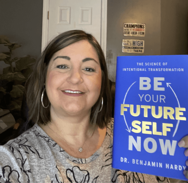 Alissa holding the book Be Your Future Self Now