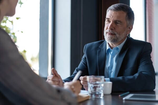 Executive businessman sitting at a table during an interview